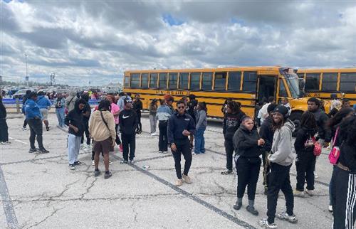 A large group of Henry Ford High School students and chaperones pose for a group photo in front of the iconic Cedar Point ent